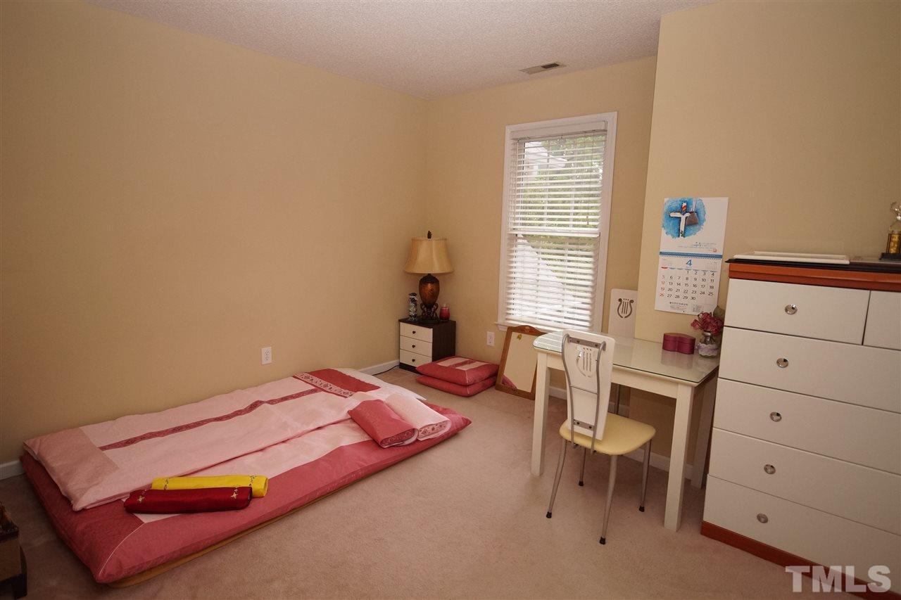 7908 Broad Street Raleigh, NC 27613 - Photo 17 of 24 a bedroom with a bed and a window