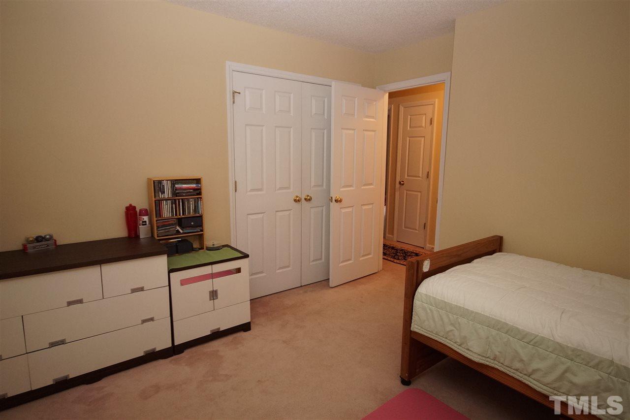 7908 Broad Street Raleigh, NC 27613 - Photo 18 of 24 a bedroom with a bed and cabinet