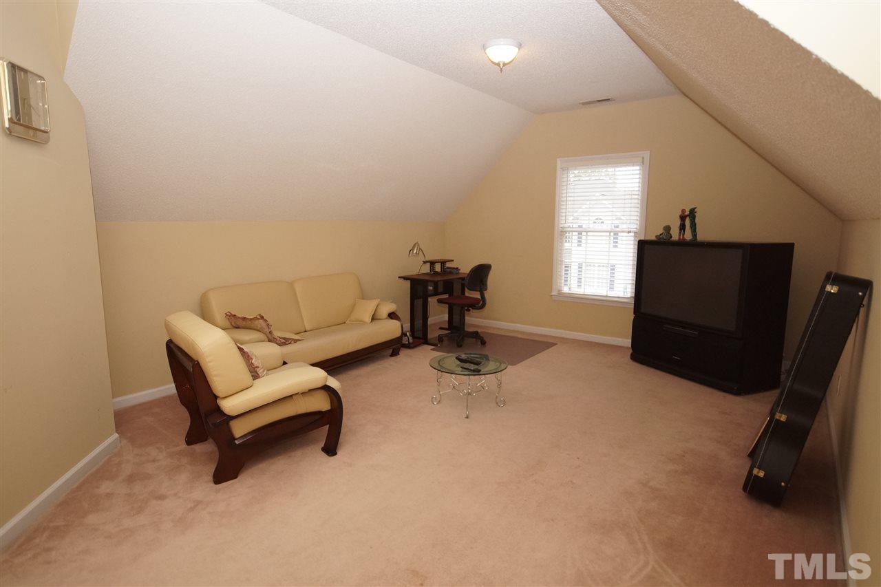 7908 Broad Street Raleigh, NC 27613 - Photo 20 of 24 a living room with furniture and a flat screen tv
