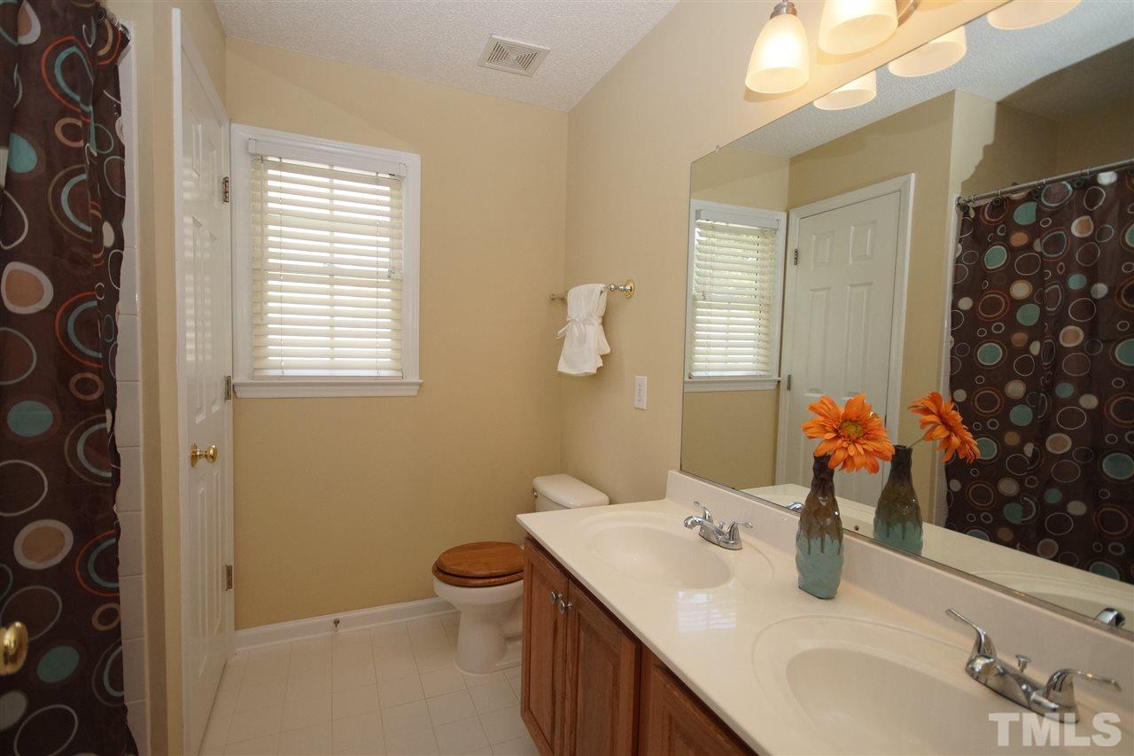 7908 Broad Street Raleigh, NC 27613 - Photo 21 of 24 a bathroom with a sink and a mirror