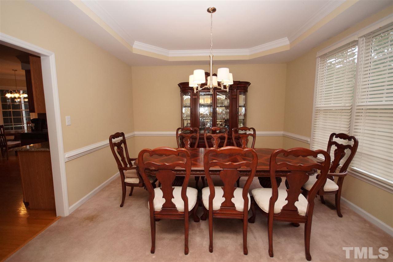 7908 Broad Street Raleigh, NC 27613 - Photo 5 of 24 a view of a dining room with furniture and chandelier