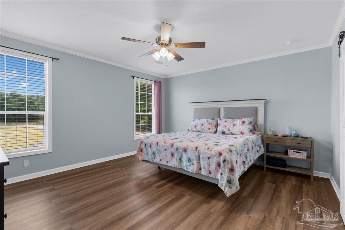 4955 Blue Ribbon Drive Milton, FL 32583 - Photo 9 of 32 a bedroom with a large bed and a window