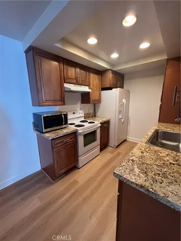 a kitchen with a stove a sink and a refrigerator