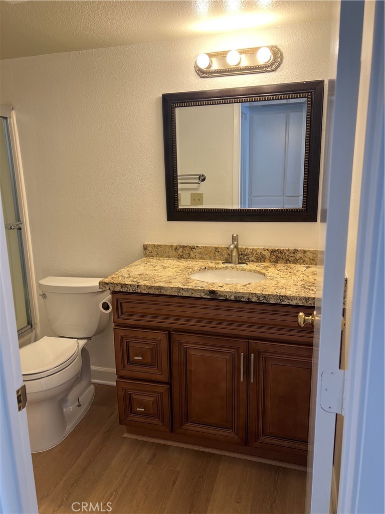 25611 Quail Run, Unit 100 Dana Point, CA 92629 - Photo 7 of 13 a bathroom with a granite countertop toilet sink and mirror