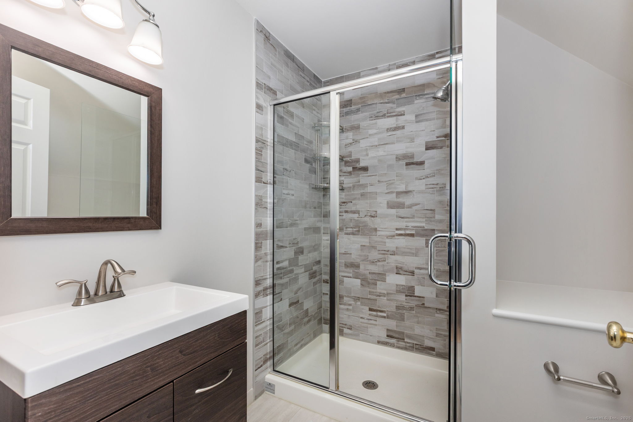 160 Glenbrook Road, Unit 3D Stamford, CT 06902 - Photo 18 of 26 a bathroom with a shower sink and mirror
