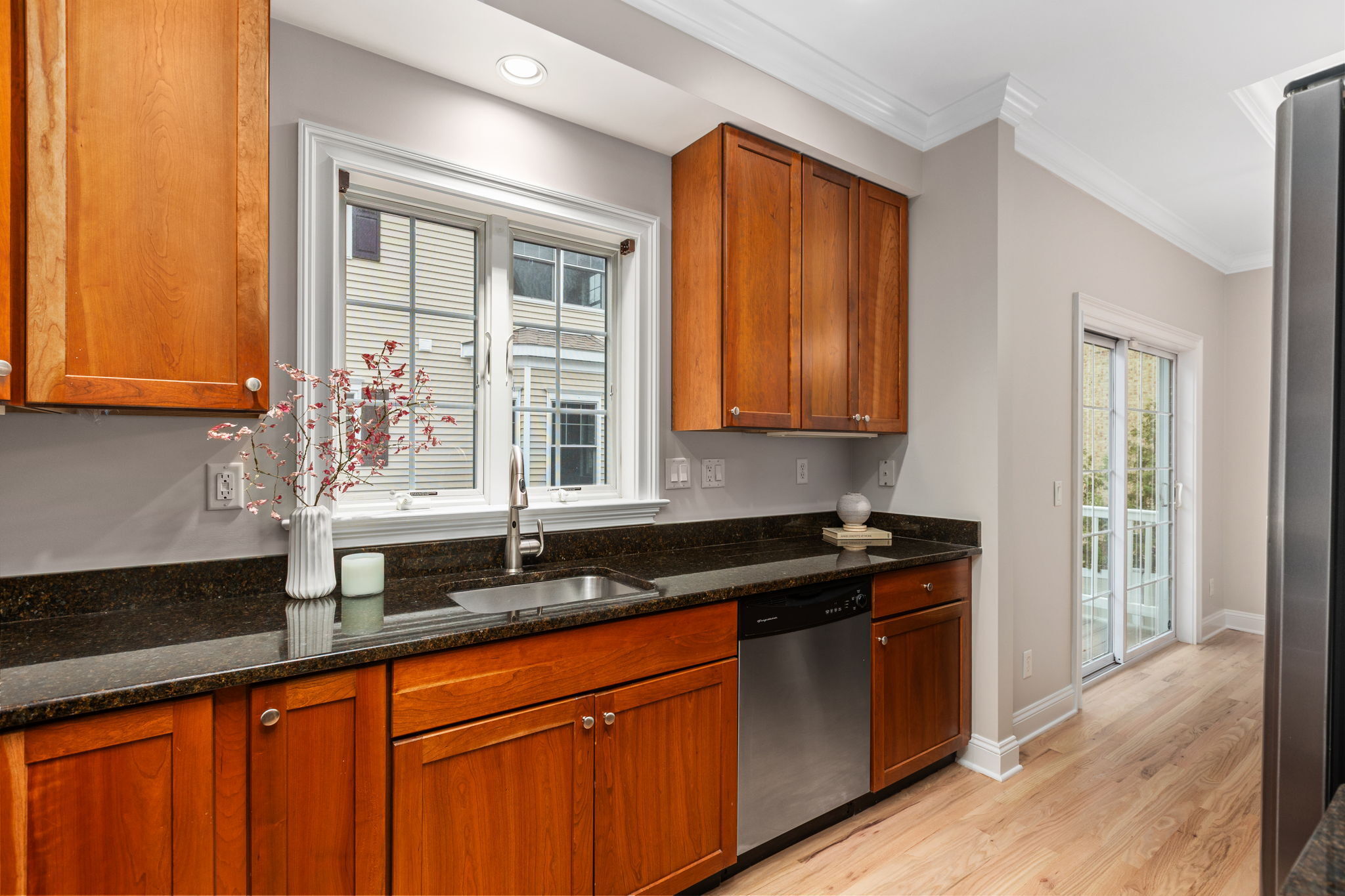 160 Glenbrook Road, Unit 3D Stamford, CT 06902 - Photo 9 of 26 a kitchen with granite countertop wooden cabinets a sink and a window