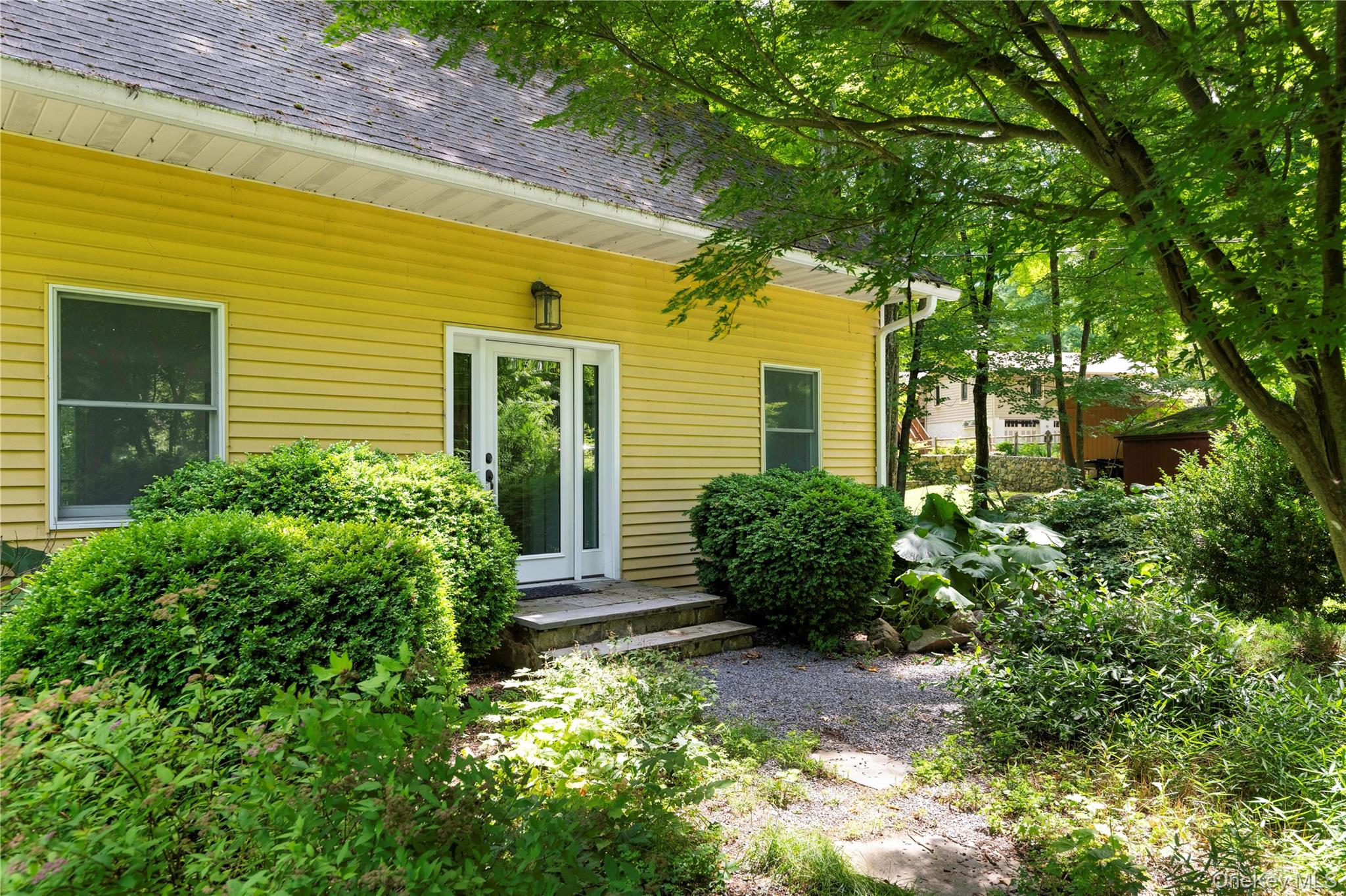 41 Chapman Road Garrison, NY 10524 - Photo 2 of 22 a view of a garden with potted plants and large trees