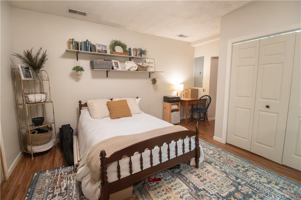 210 Whitestown Road Butler, PA 16001 - Photo 12 of 19 a bedroom with a bed and wooden floor