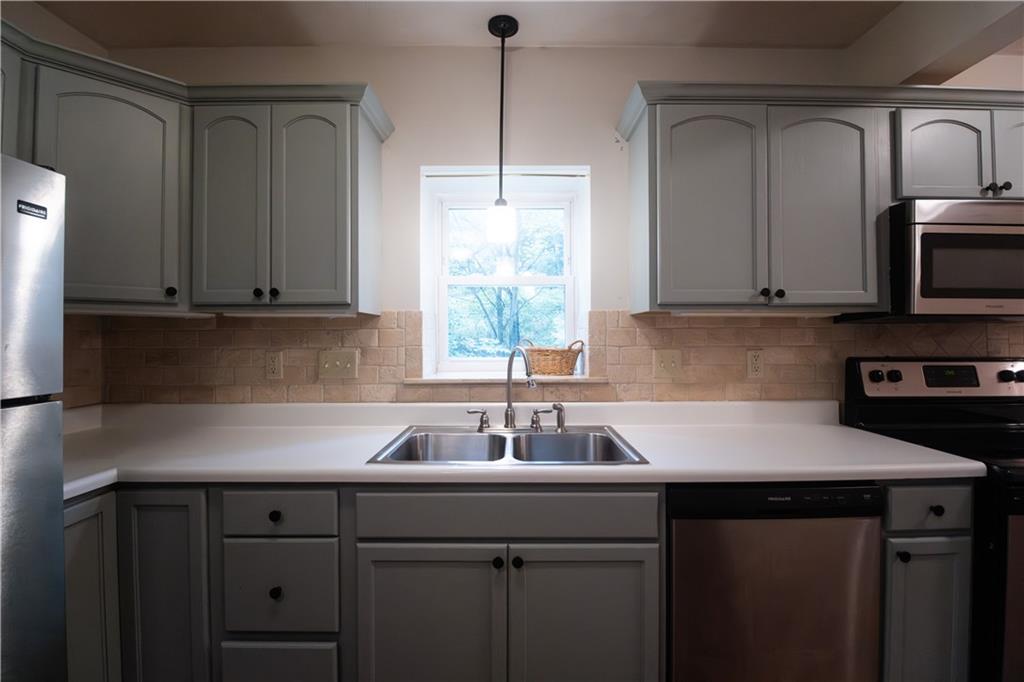 210 Whitestown Road Butler, PA 16001 - Photo 4 of 19 a kitchen with stainless steel appliances granite countertop a sink a microwave cabinets and a window
