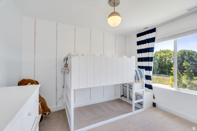 646 South Meade Street Mapleton, UT 84664 - Photo 17 of 46 Room featuring a large window, light-colored carpeting, and a built-in bed frame with storage