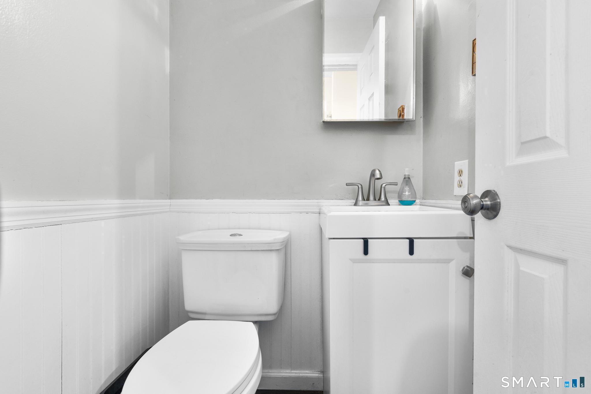 84 Taylor Avenue, Unit 1 Norwalk, CT 06854 - Photo 12 of 40 a bathroom with a sink a toilet and mirror