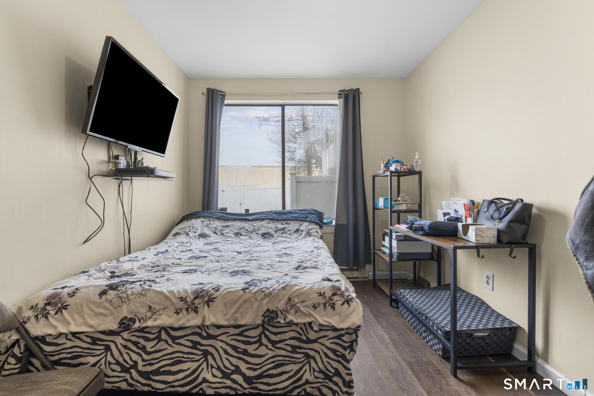 84 Taylor Avenue, Unit 1 Norwalk, CT 06854 - Photo 15 of 40 a bedroom with a bed and a flat screen tv