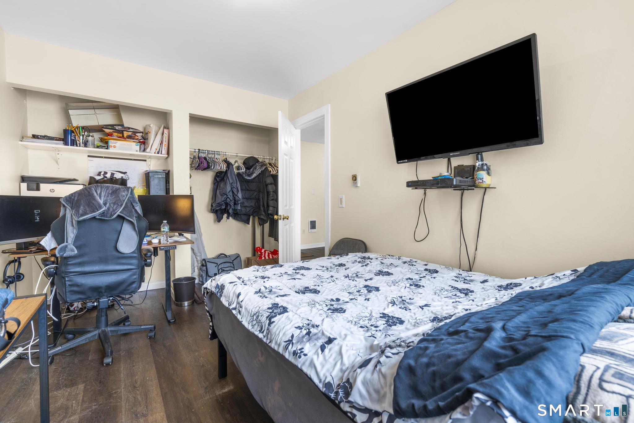 84 Taylor Avenue, Unit 1 Norwalk, CT 06854 - Photo 16 of 40 a bedroom with a bed and a flat screen tv