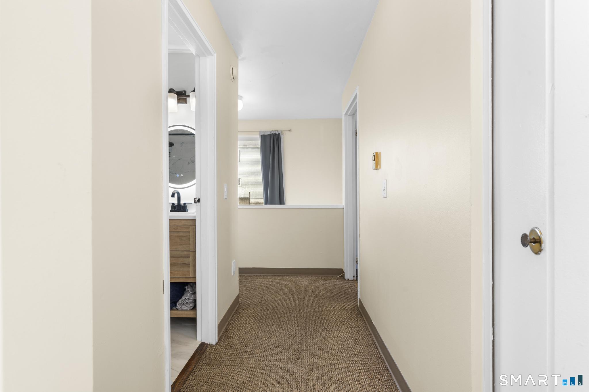 84 Taylor Avenue, Unit 1 Norwalk, CT 06854 - Photo 18 of 40 a view of a hallway with white walls