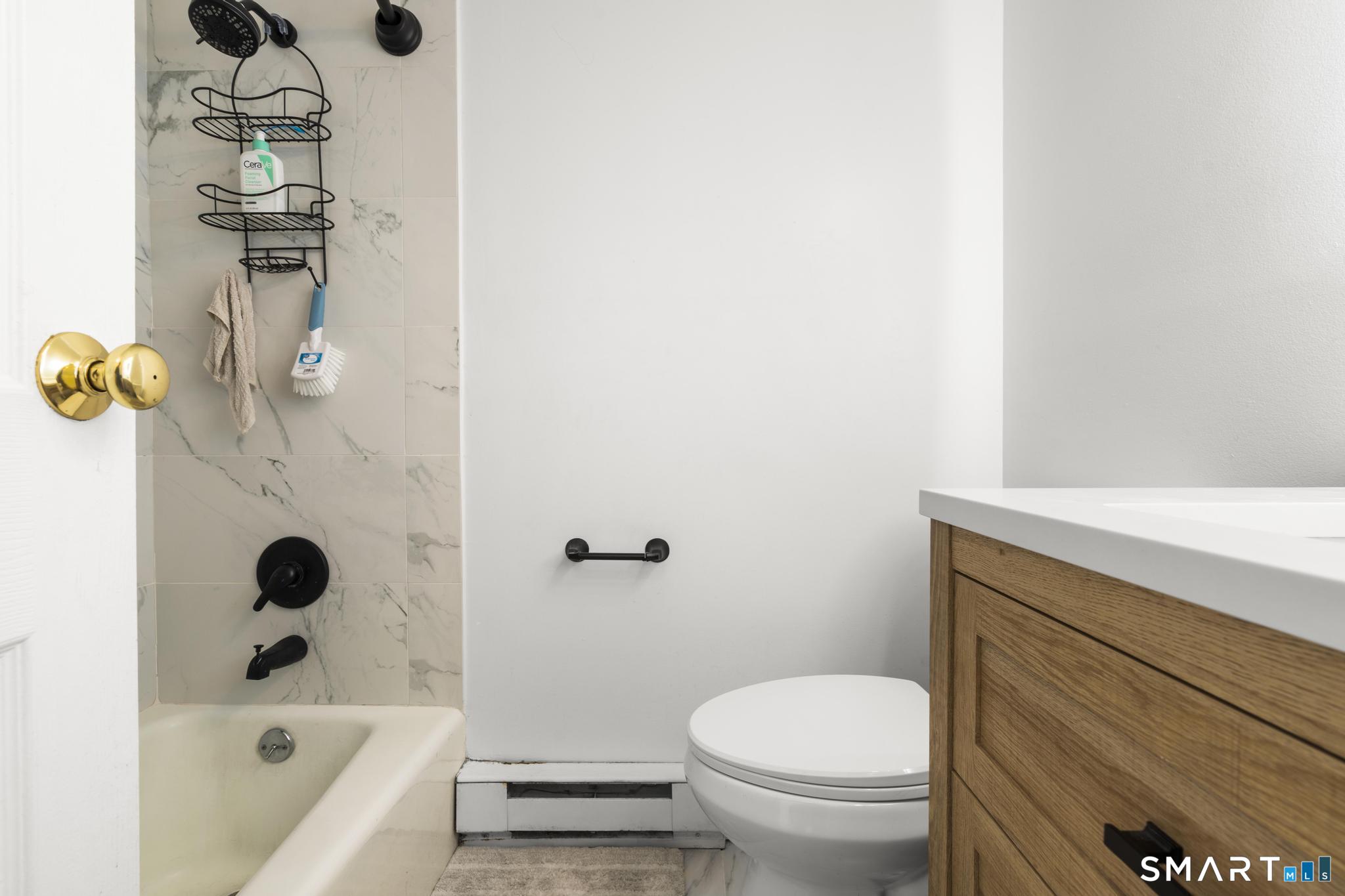 84 Taylor Avenue, Unit 1 Norwalk, CT 06854 - Photo 19 of 40 a bathroom with a bathtub and shower