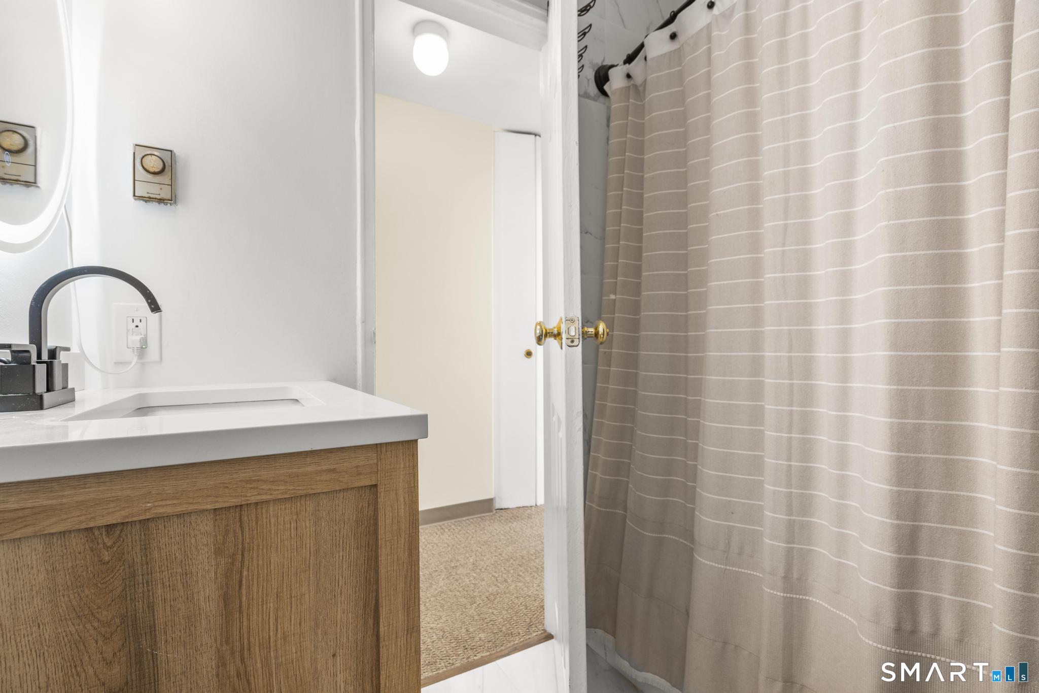 84 Taylor Avenue, Unit 1 Norwalk, CT 06854 - Photo 23 of 40 a bathroom with a sink and a mirror