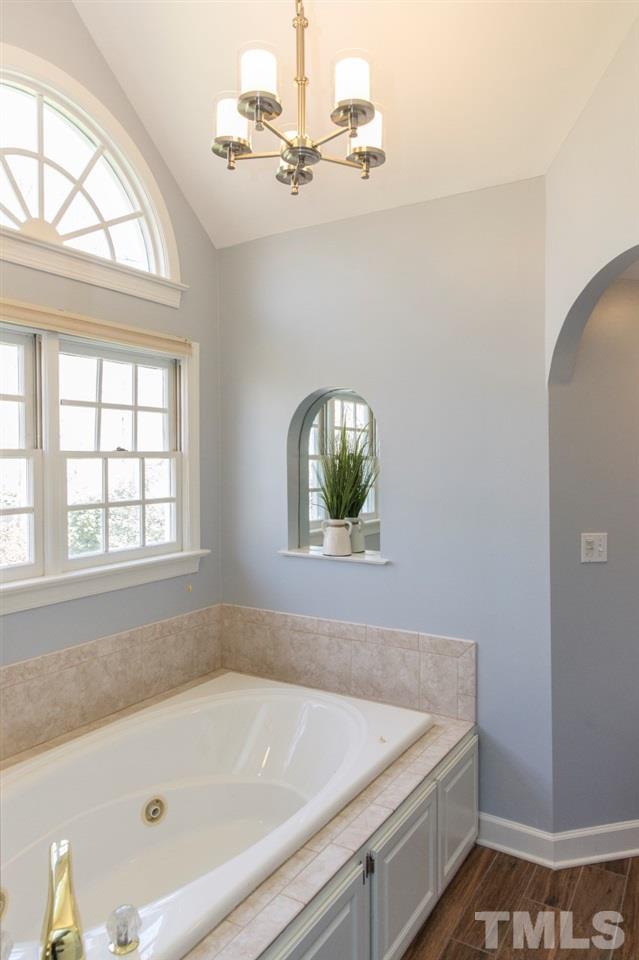 2804 London Bridge Court Raleigh, NC 27613 - Photo 14 of 25 a bathroom with a tub and a window