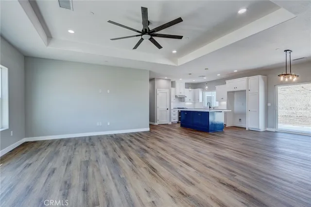 a view of empty room with wooden floor and window