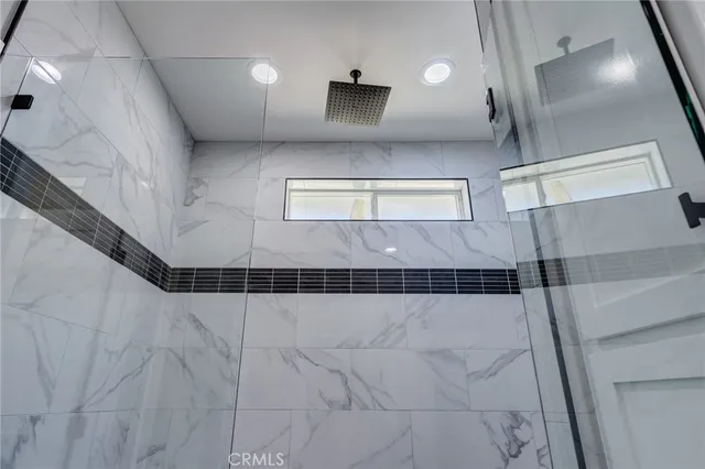 a view of empty room with wooden floor and window