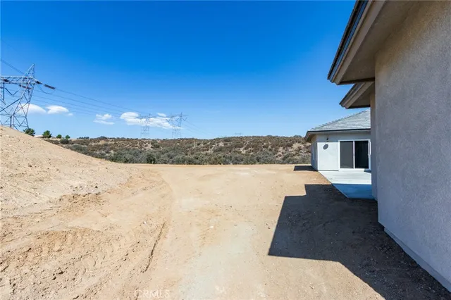 a view of garage with a small yard