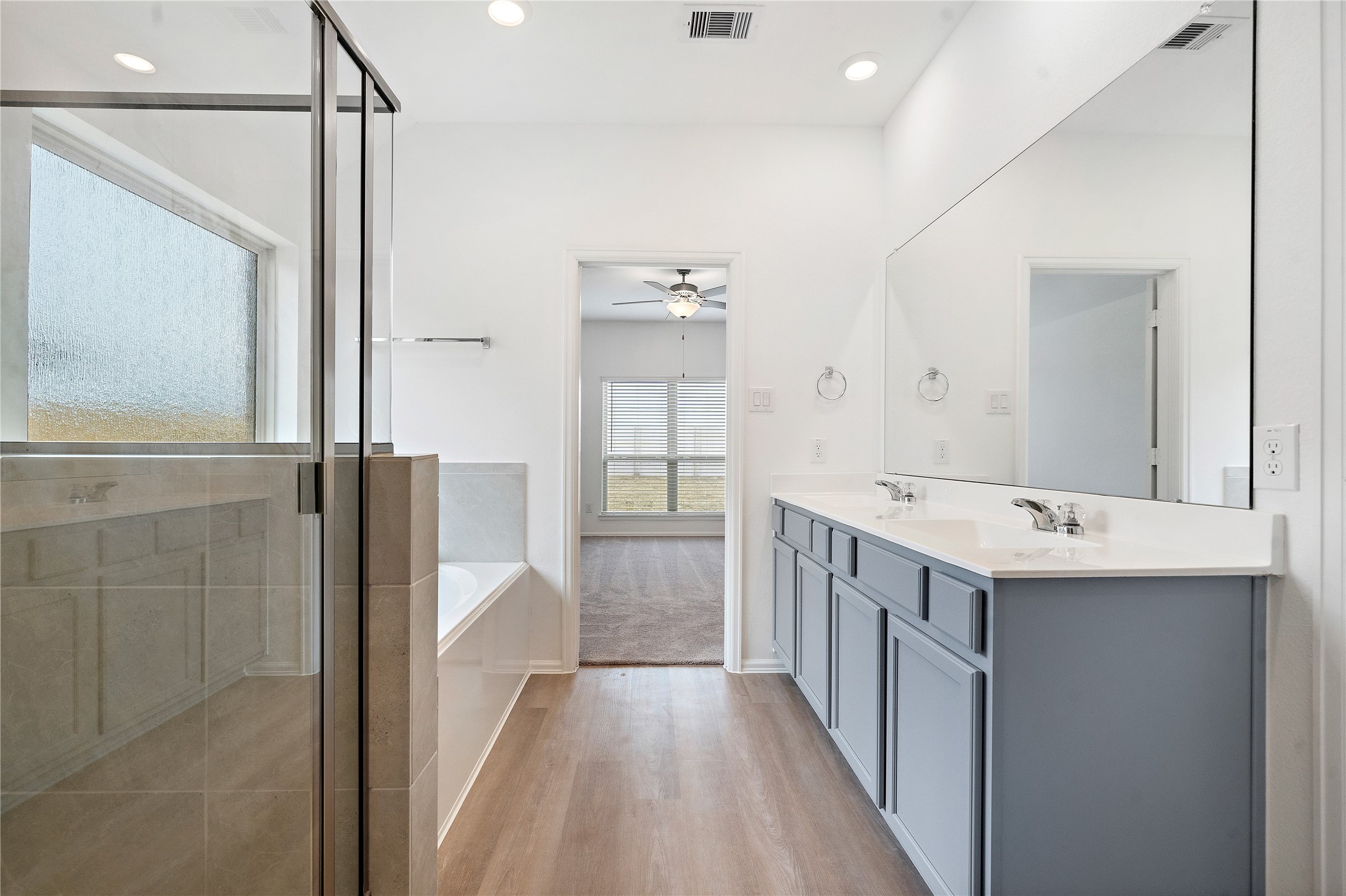 3731 Lion Creek Rosenberg, TX 77469 - Photo 11 of 13 Primary bathroom featuring dual sinks, glass shower, and modern finishes.