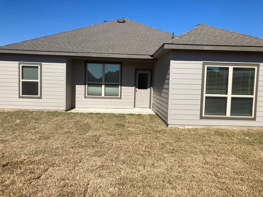3731 Lion Creek Rosenberg, TX 77469 - Photo 13 of 13 Rear exterior view showcasing covered patio and backyard space.