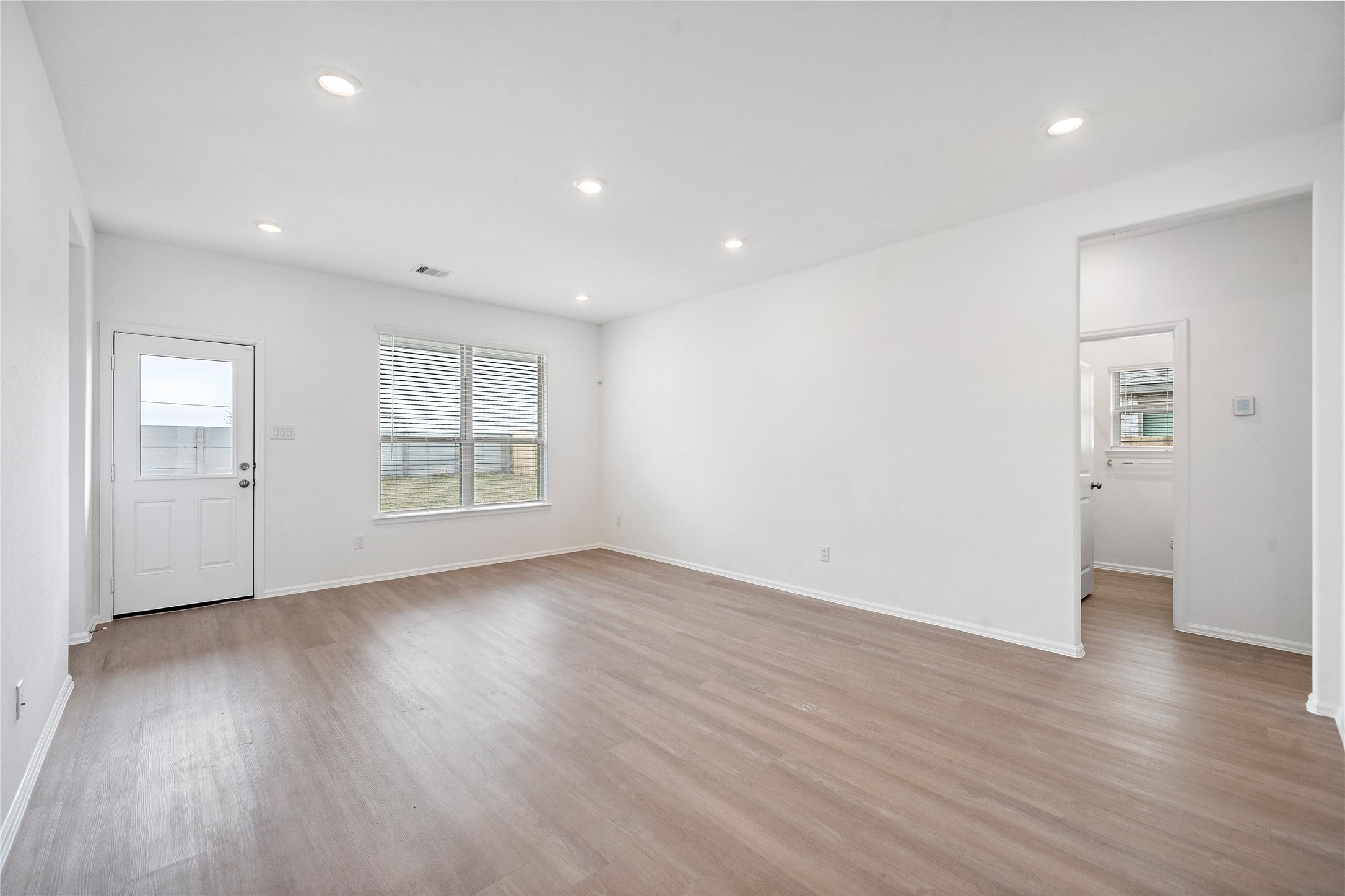 3731 Lion Creek Rosenberg, TX 77469 - Photo 6 of 13 Spacious family room with wood-style flooring and abundant natural light.