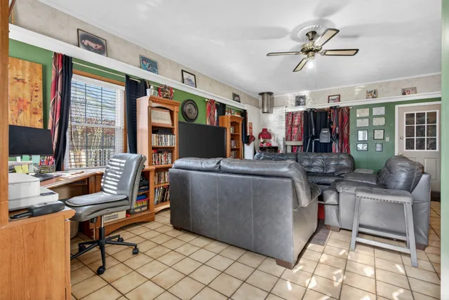 a living room with furniture ceiling fan and a rug