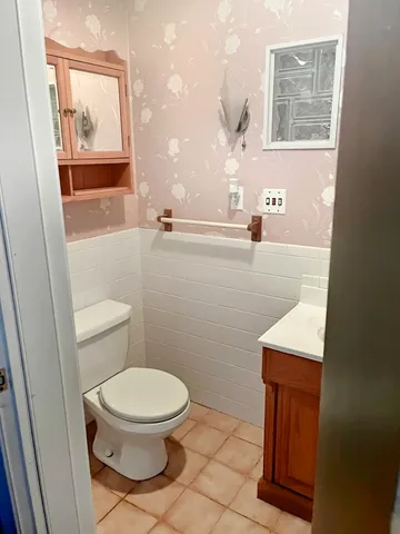 a bathroom with a sink a vanity and a mirror