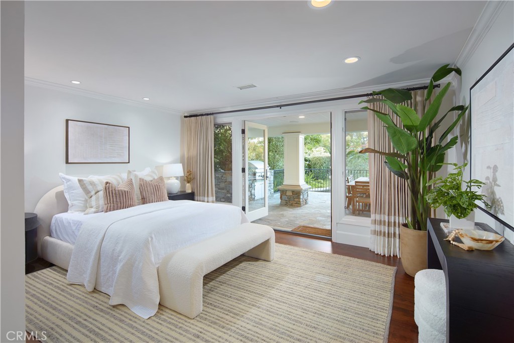 2 Royal St George Road Newport Beach, CA 92660 - Photo 24 of 48 a bedroom with a large bed and a potted plant