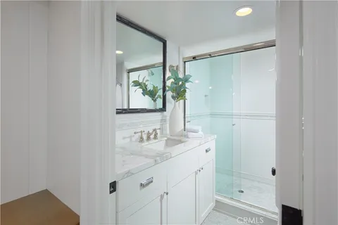 a bathroom with a shower sink and mirror
