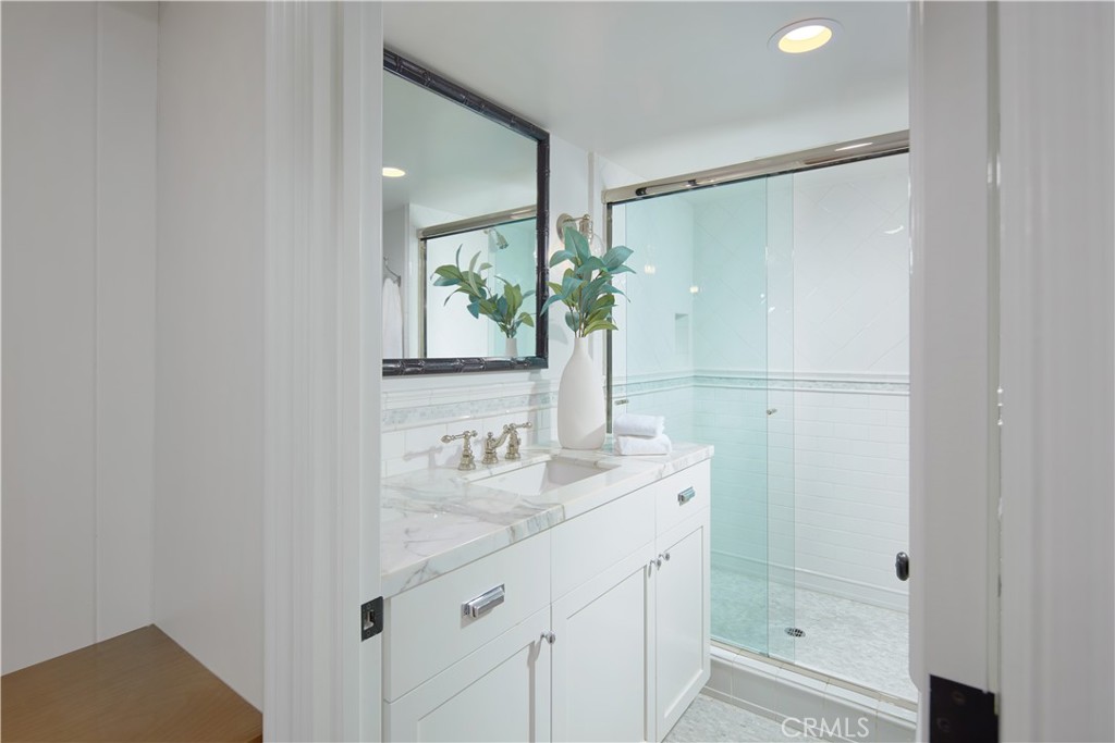 2 Royal St George Road Newport Beach, CA 92660 - Photo 28 of 48 a bathroom with a shower sink and mirror