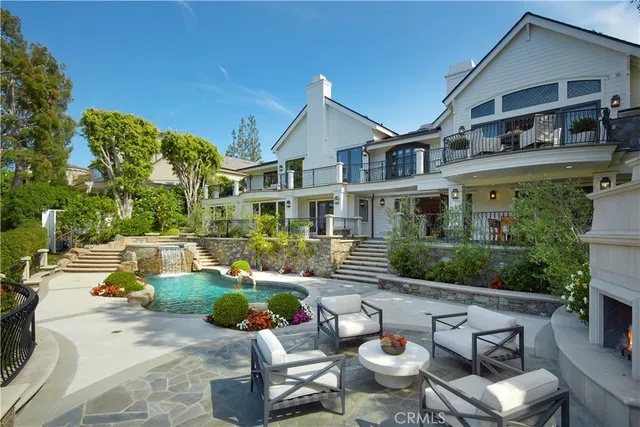 a view of a patio with couches table and chairs and potted plants