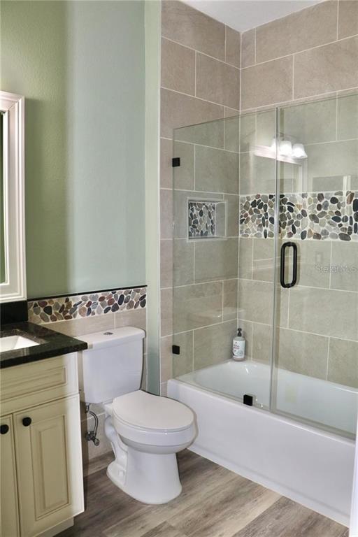 13548 Turtle Marsh Loop, Unit 413 Orlando, FL 32837 - Photo 14 of 27 a bathroom with a sink a toilet and shower