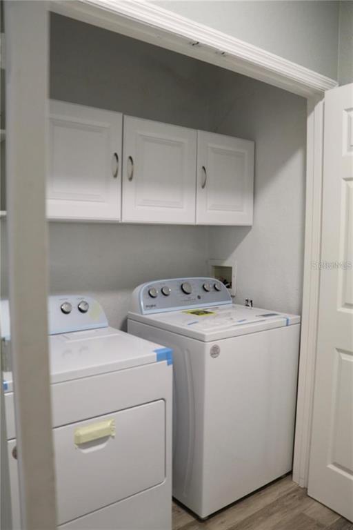 13548 Turtle Marsh Loop, Unit 413 Orlando, FL 32837 - Photo 17 of 27 a utility room with dryer and washer