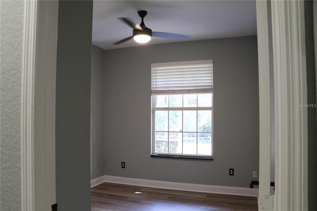 13548 Turtle Marsh Loop, Unit 413 Orlando, FL 32837 - Photo 18 of 27 a view of an empty room with wooden floor and a window