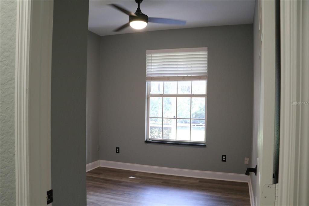 13548 Turtle Marsh Loop, Unit 413 Orlando, FL 32837 - Photo 19 of 27 an empty room with a window and ceiling fan