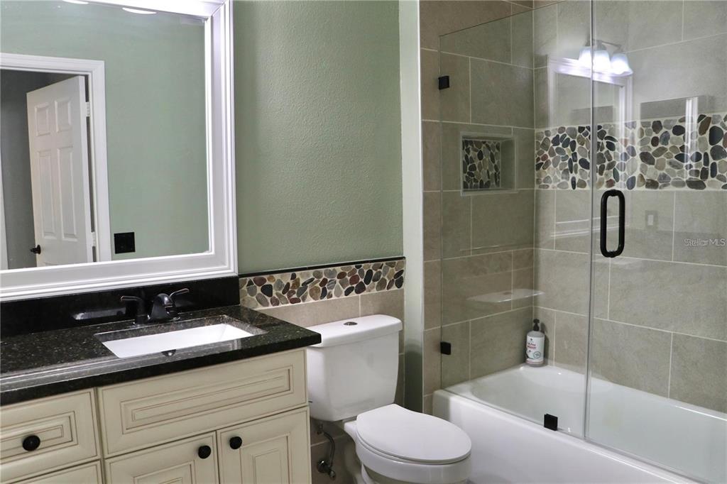 13548 Turtle Marsh Loop, Unit 413 Orlando, FL 32837 - Photo 20 of 27 a bathroom with a sink a toilet and shower