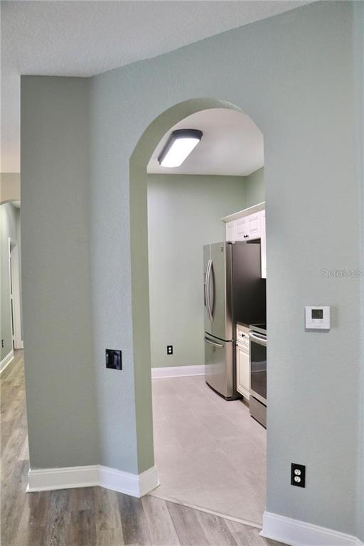13548 Turtle Marsh Loop, Unit 413 Orlando, FL 32837 - Photo 6 of 27 a view of a kitchen with a sink and a refrigerator