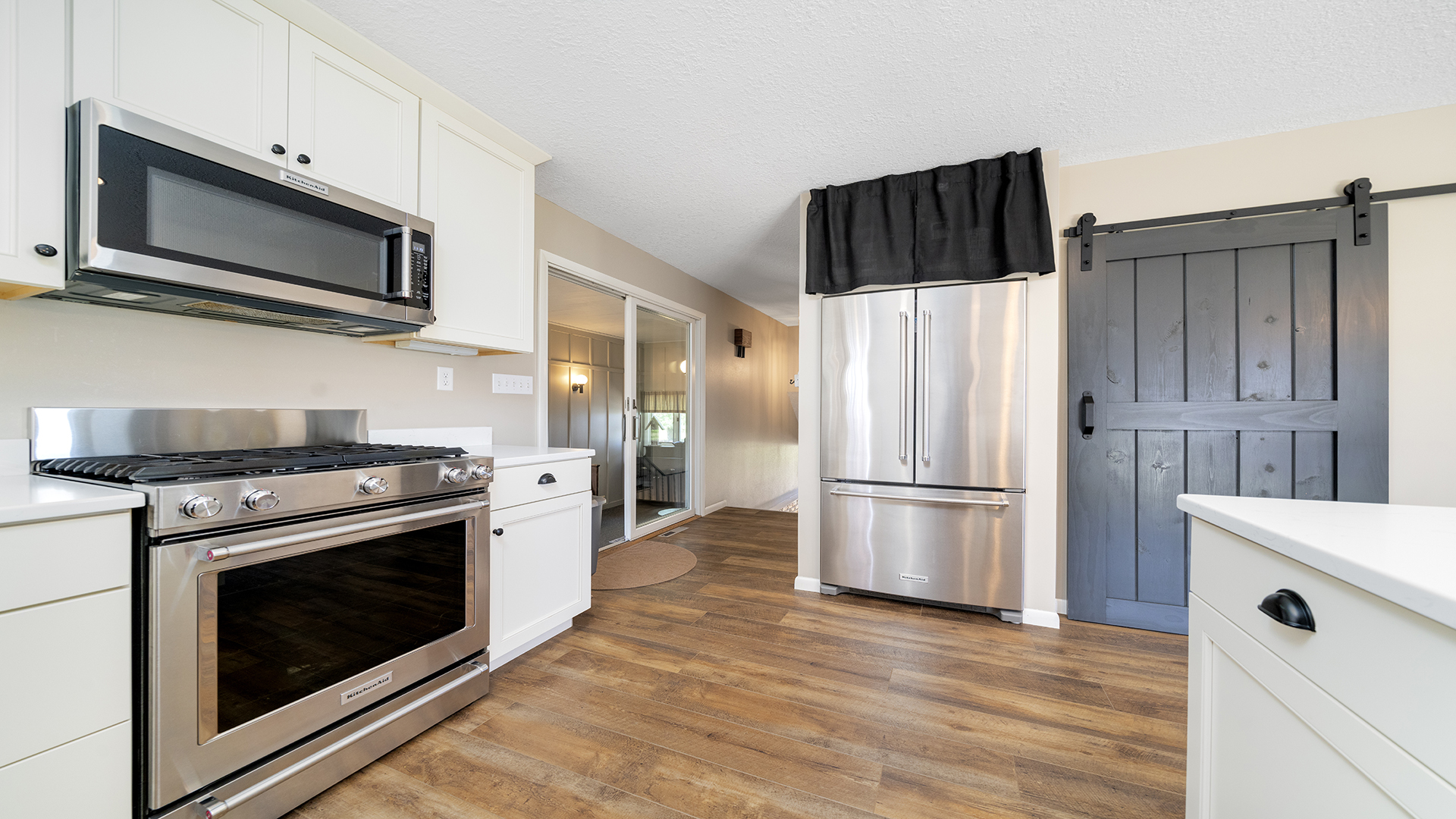 1195 Atkinson Road Harmon, IL 61042 - Photo 10 of 53 a kitchen with stainless steel appliances white cabinets and a stove top oven