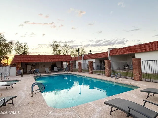 a swimming pool with outdoor seating and yard