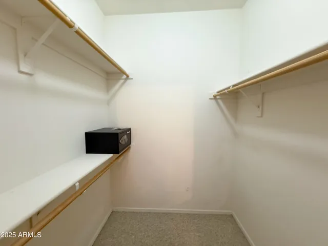 an empty room with a ceiling fan and window