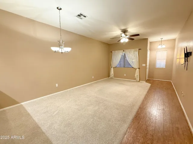 a view of empty room with a ceiling fan