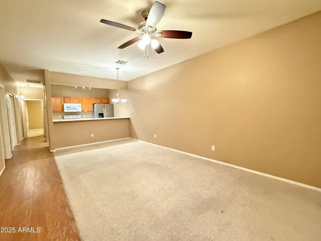a view of a livingroom with a ceiling fan and window