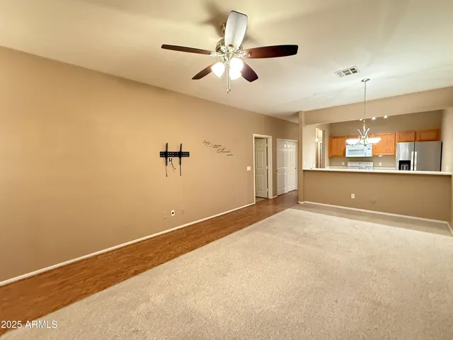 a kitchen with refrigerator and cabinets