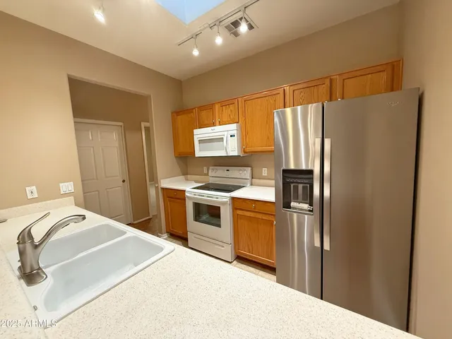 an empty room with windows and ceiling fan
