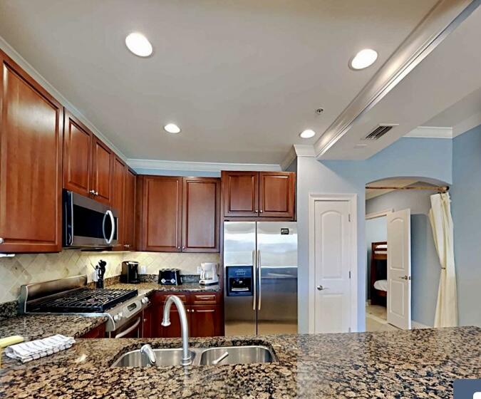 2421 West County Highway 30A, Unit E303 Santa Rosa Beach, FL 32459 - Photo 12 of 23 a kitchen with stainless steel appliances granite countertop a refrigerator stove and sink
