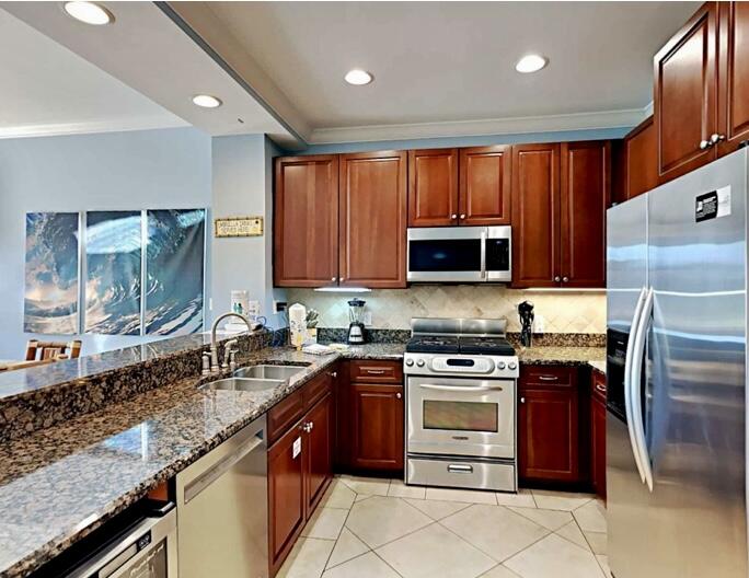 2421 West County Highway 30A, Unit E303 Santa Rosa Beach, FL 32459 - Photo 13 of 23 a kitchen with stainless steel appliances granite countertop a stove sink microwave and refrigerator