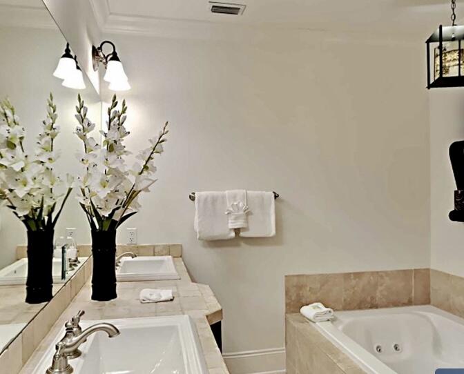 2421 West County Highway 30A, Unit E303 Santa Rosa Beach, FL 32459 - Photo 17 of 23 a bathroom with a sink a toilet and mirror