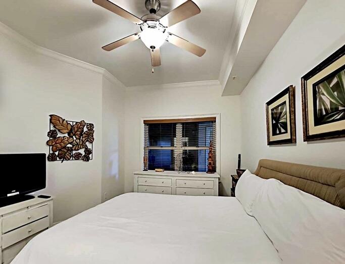 2421 West County Highway 30A, Unit E303 Santa Rosa Beach, FL 32459 - Photo 19 of 23 a bedroom with a large bed and a flat screen tv